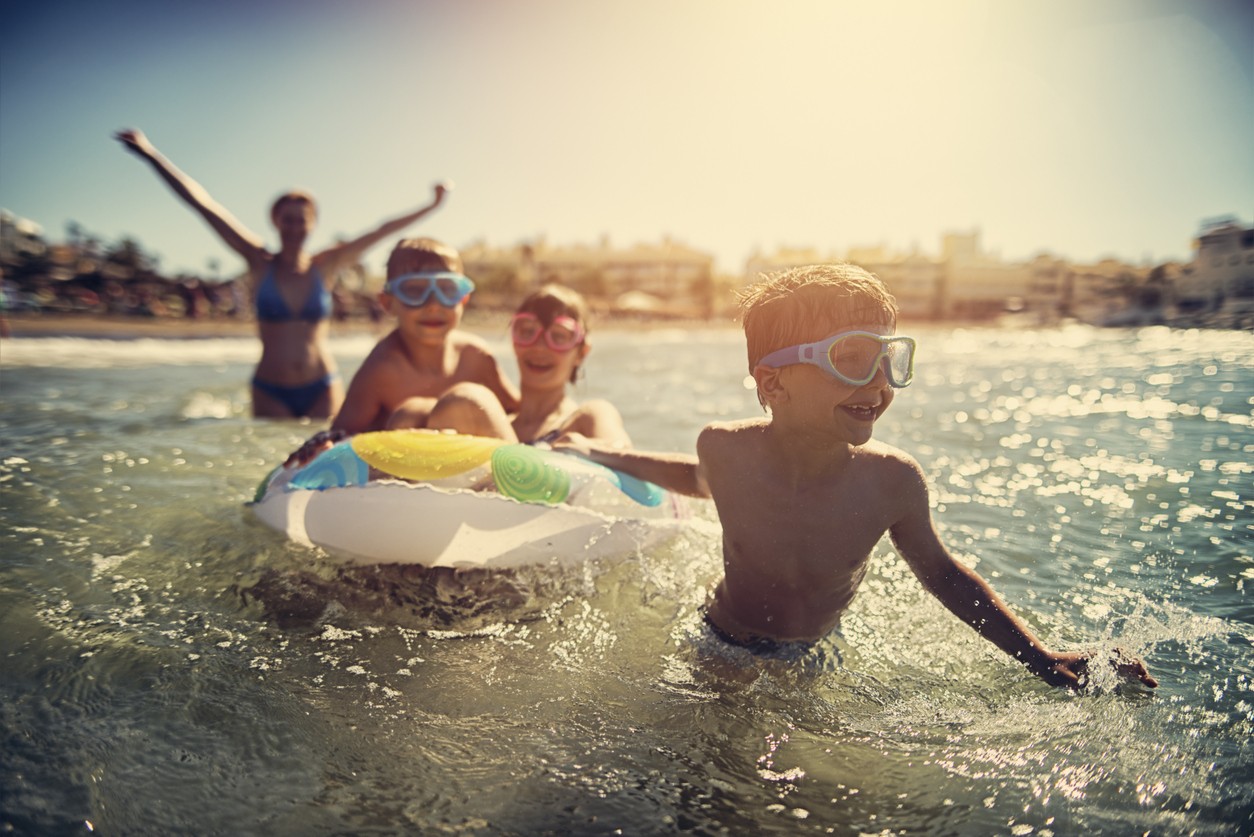 Children Playing in Sea on Holiday