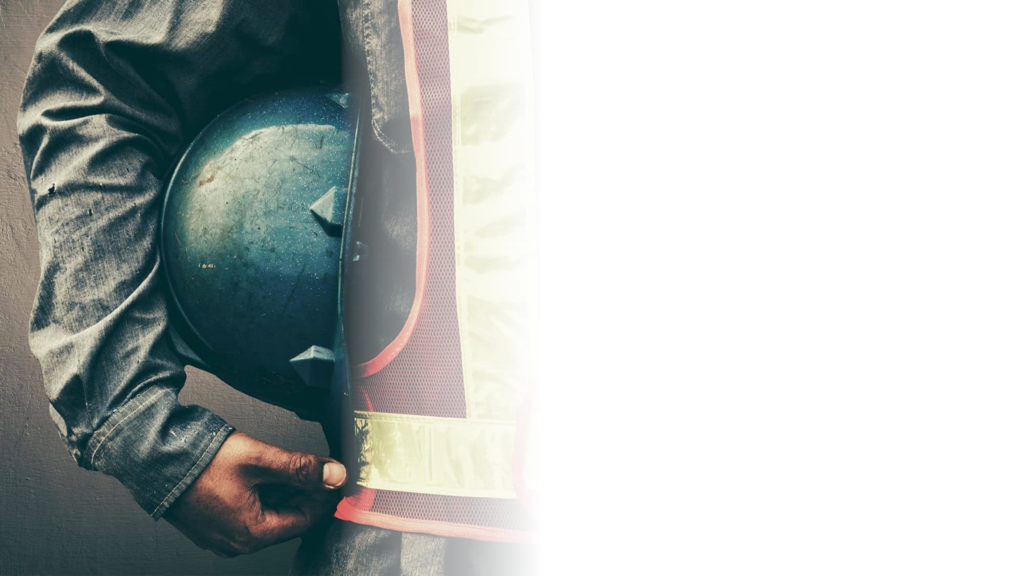 Construction Worker Holding Hardhat